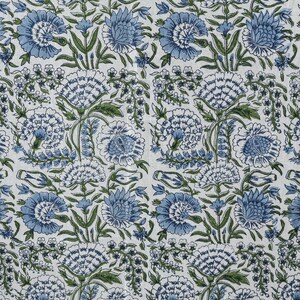 Round blue and white floral hand block printed cotton tablecloth, featuring intricate Indian design with green accents. Perfect dining table cover for farmhouse, cottagecore, or boho decor. Ideal for weddings, housewarming gifts, summer dining, or festive celebrations. Handmade by skilled artisans using traditional block printing techniques. Fits large round tables beautifully, adding elegance to your dining space.