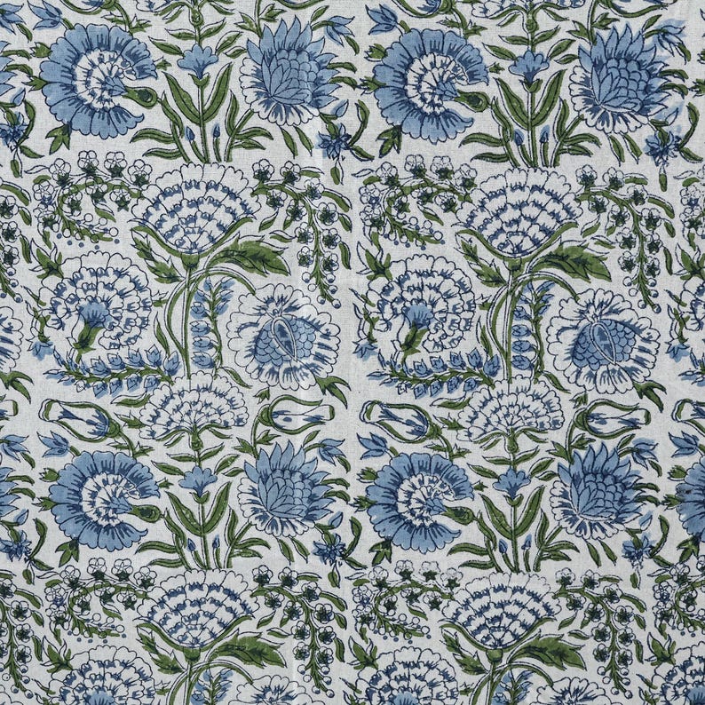 Round blue and white floral hand block printed cotton tablecloth, featuring intricate Indian design with green accents. Perfect dining table cover for farmhouse, cottagecore, or boho decor. Ideal for weddings, housewarming gifts, summer dining, or festive celebrations. Handmade by skilled artisans using traditional block printing techniques. Fits large round tables beautifully, adding elegance to your dining space.