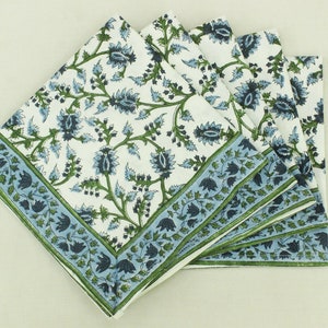 May include: Set of five cotton napkins with a blue and green floral pattern. The napkins have a white background with a blue and green floral pattern and a blue and green border.