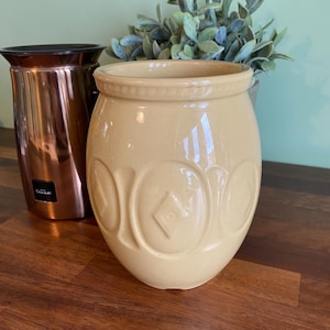 May include: A set of three ceramic mugs with a speckled, matte finish in cream, light grey, and dark grey. Each mug has a simple, minimalist design, suitable for coffee or tea.