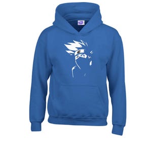 May include: A royal blue hooded sweatshirt featuring a white graphic of a character's face. The graphic includes spiky hair, a mask, and a headband. The sweatshirt has a kangaroo pocket and a drawstring hood. The tag on the hood says "Custom Shirts".