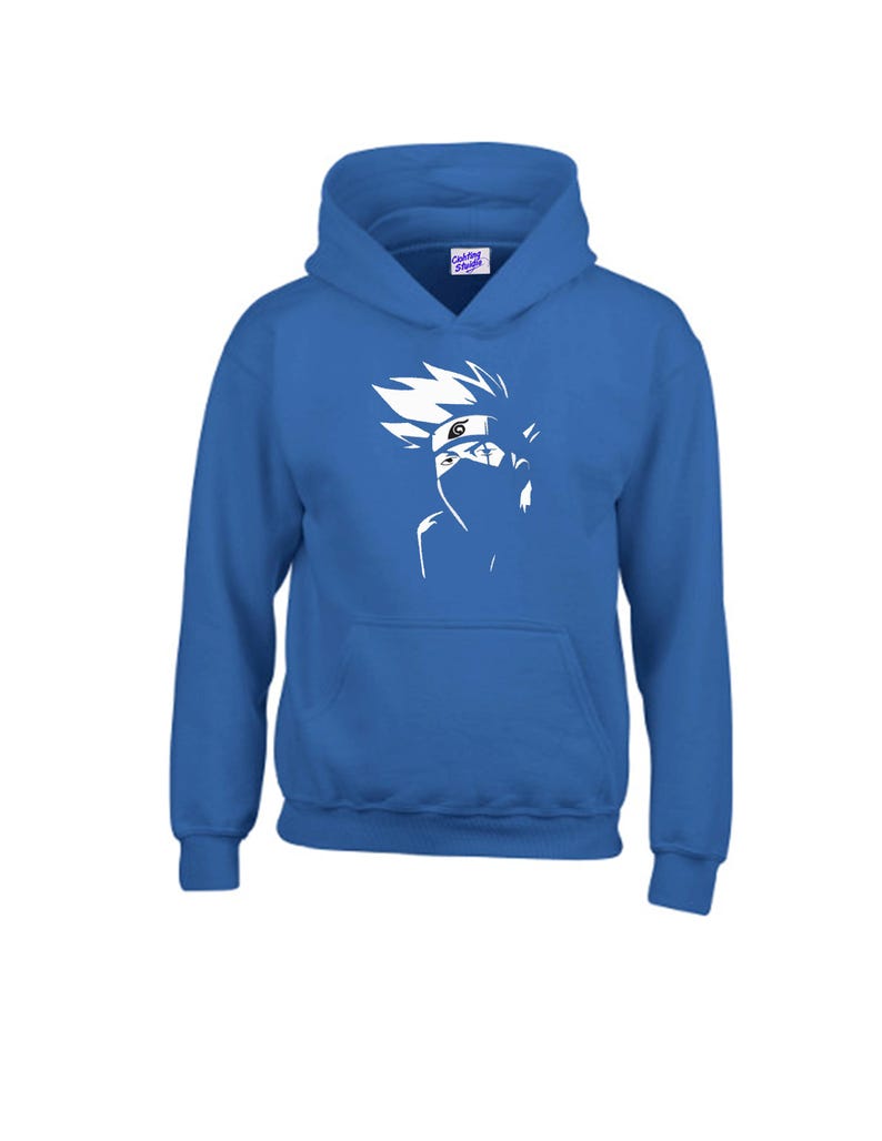 May include: A royal blue hooded sweatshirt featuring a white graphic of a character's face. The graphic includes spiky hair, a mask, and a headband. The sweatshirt has a kangaroo pocket and a drawstring hood. The tag on the hood says "Custom Shirts".