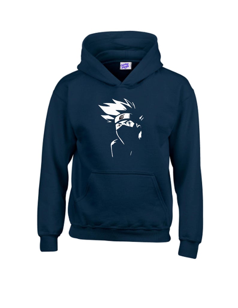 May include: Navy blue hooded sweatshirt featuring a white graphic of a character's face with spiky hair and a mask. The sweatshirt has a front pocket and a drawstring hood. The brand name "Clothing Shades" is printed on the upper right corner.