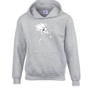May include: A gray hooded sweatshirt with a white graphic of a character's face. The sweatshirt has a front pocket and a drawstring hood. The graphic is a stylized illustration of a character with spiky hair and a mask.