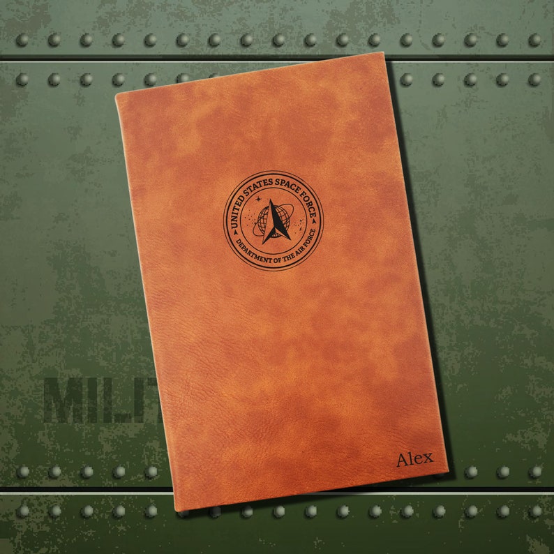 May include: A brown leather journal with the United States Space Force logo and the name "Alex" embossed on the cover.