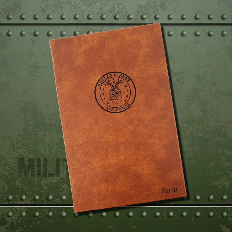 May include: A brown leather journal with the United States Air Force seal embossed on the front. The name "Sam" is embossed on the bottom right corner.