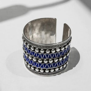 eep Blue Studs Cuff Bracelet inspired by Amazigh tattoos and the blue indigo of the Atlantic Ocean: Symbolic freedom, Cultural infusion, Striking elegance, Artistic expressions, Oceanic inspiration.