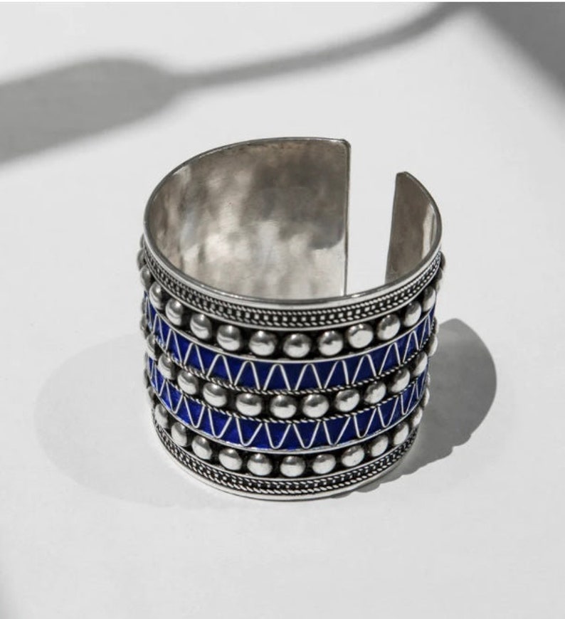 eep Blue Studs Cuff Bracelet inspired by Amazigh tattoos and the blue indigo of the Atlantic Ocean: Symbolic freedom, Cultural infusion, Striking elegance, Artistic expressions, Oceanic inspiration.