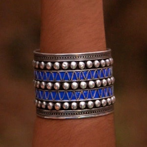 Symbolic freedom: The deep blue studs on this cuff bracelet represent the oceanic hues of the Atlantic, embodying the meaning of freedom cherished by the Berber people and their ancestral connection to the sea.