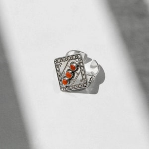 Coral Diamond Ring: Exquisite elegance, Captivating beauty, Handcrafted perfection, Vibrant coral hue, Dazzling diamonds, Timeless allure, Fine craftsmanship, Unique statement.