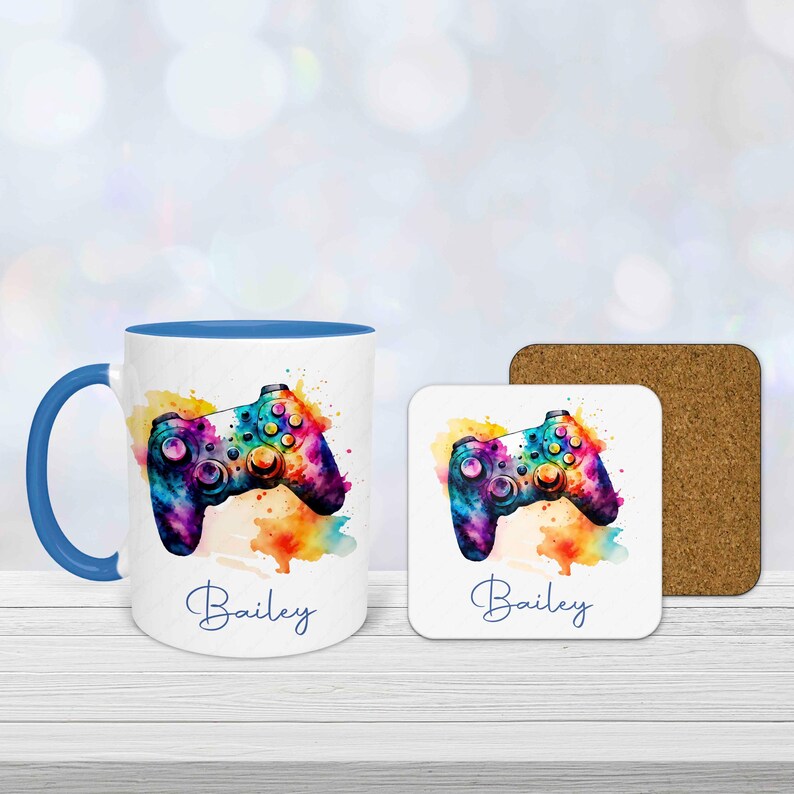 Personalised gamer mug and coaster set with colourful watercolour gaming controller design and custom name printed underneath.  Mug has a blue handle and is blue inside.