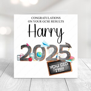 May include: A white card with black text that reads "Congratulations on your GCSE results Harry 2025 You did it!!!". The card has a chalkboard background with school supplies like a globe, a pencil, a book, a calculator, a clock, and a graduation cap.