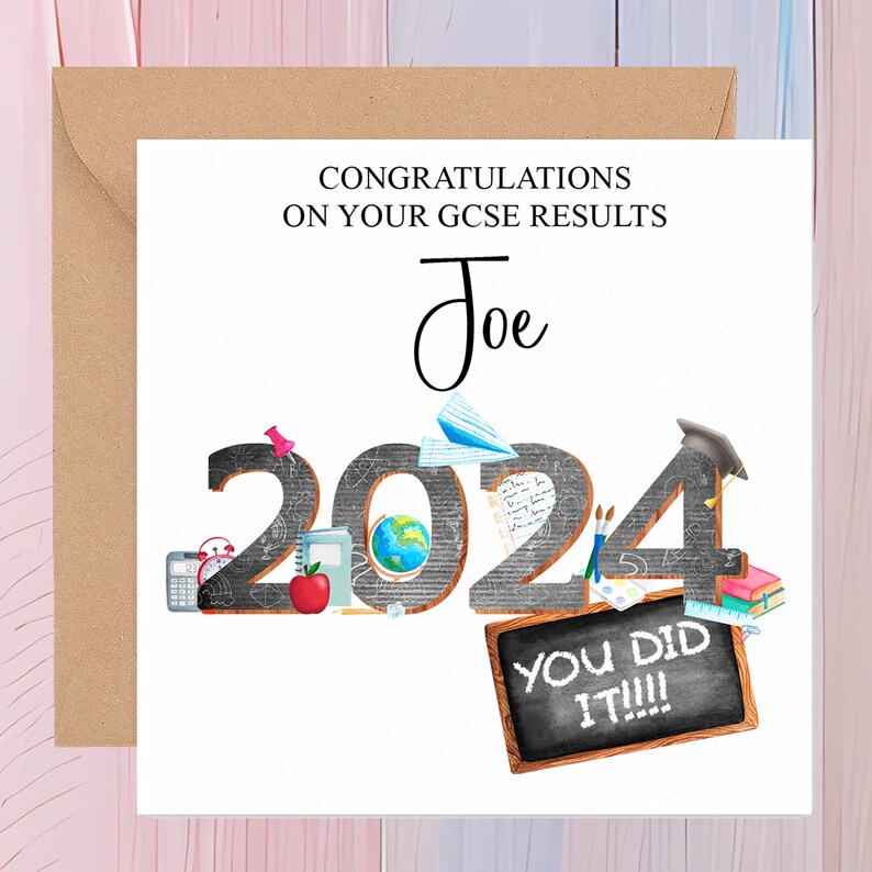 May include: A white card with a brown envelope. The card has a black and white illustration of the year 2024 with school supplies and the text "Congratulations on your GCSE results Joe You Did It!!!".