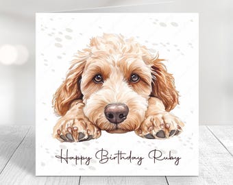 Peut inclure: Une carte d'anniversaire illustrant un adorable chiot caniche brun clair avec le texte "Happy Birthday Ruby" sur fond blanc.