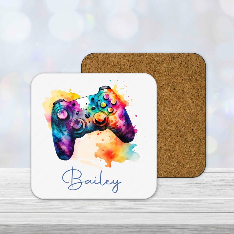 Personalised gamer coaster with colourful watercolour gaming controller design and custom name printed underneath.