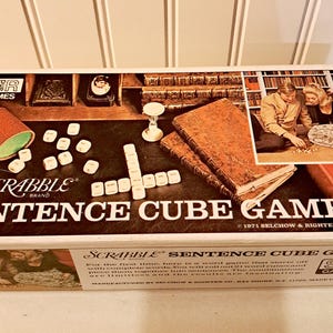 May include: Vintage Scrabble Sentence Cube Game box. The box features the game title in large letters, dice, and a picture of people playing the game. The game box is white with a brown and black game board design.