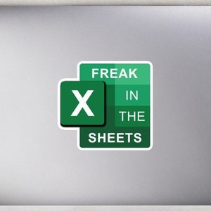 May include: A green and white sticker with the text "Freak in the sheets" and a green "X" in the center. The sticker is on a silver laptop computer.