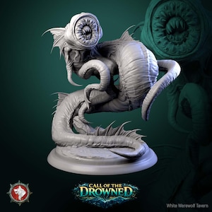 May include: A grey sculpture of a monstrous creature with a large, toothed mouth and multiple tentacles. The sculpture has a fish-like body and is mounted on a circular base. The text "CALL OF THE DROWNED" is at the bottom.