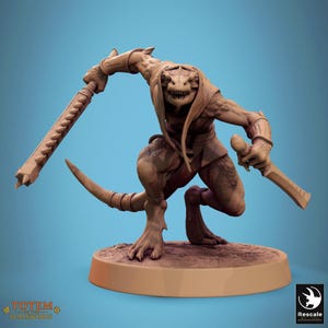 May include: A detailed figurine of a reptilian humanoid creature, posed dynamically with two bladed weapons. The figure is brown with a long tail and is on a circular base. The text "TOTEM OF THE SCALEWINGS" is visible.