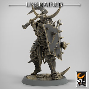 May include: A detailed miniature figure of a warrior in gold and black armor, holding a large axe and a shield with a skull. The figure is standing on a circular base. The text "UNCHAINED" is visible at the top of the image.