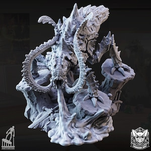 May include: A detailed, grey 3D-printed miniature of a monstrous creature, possibly for tabletop gaming. The creature has multiple limbs, a large head, and is positioned on a rocky base. The base includes swords and other details. The image is well-lit.