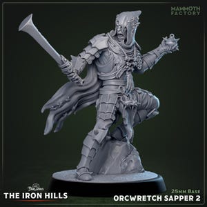 May include: A gray Orcwretch Sapper 2 miniature figure from The Iron Hills, holding a large blade and a spiked orb. The figure is posed on a rocky base, with the Mammoth Factory logo in the top right corner. The base is 25mm.