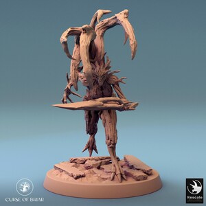 May include: A light brown resin miniature figure of a humanoid creature with tree-like bark textures, multiple branch-like appendages extending from its back, and a sharp, elongated wooden blade held in its right hand, standing on a circular base.