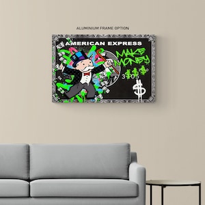 May include: A framed artwork featuring a Monopoly-inspired design with the text "AMERICAN EXPRESS" and "MAKE MONEY." The artwork depicts a Monopoly character with a top hat and cane, surrounded by dollar signs and graffiti-style accents in green and blue.