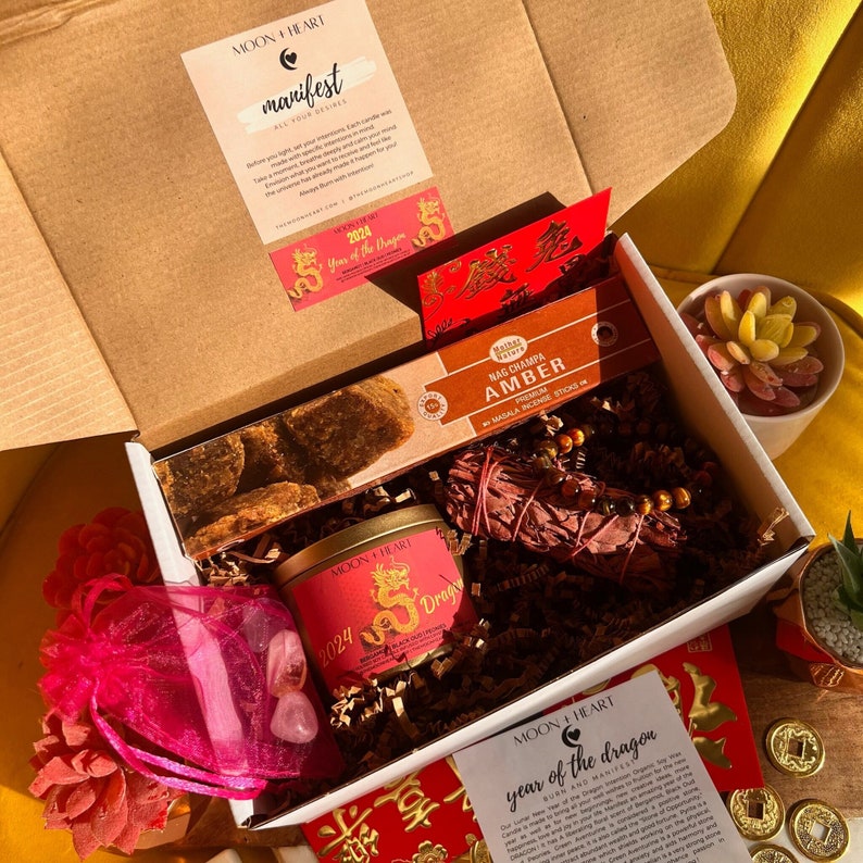 A cardboard box with a variety of Lunar New Year themed gifts inside