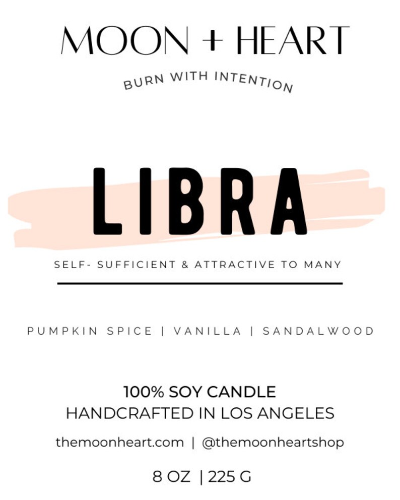 May include: A candle with a peach-colored background and the text "LIBRA" in black. The candle is a 100% soy candle, handcrafted in Los Angeles. The scent is pumpkin spice, vanilla, and sandalwood. The candle is 8 ounces or 225 grams.
