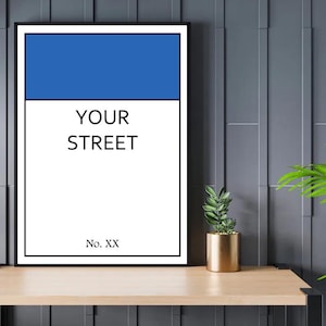 May include: A black framed print with a white background and blue rectangle at the top. The text "YOUR STREET" is in black text and "No. XX" is in black text at the bottom.