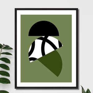 May include: A framed print with a geometric design featuring black, white, and green semi-circles on a green background.