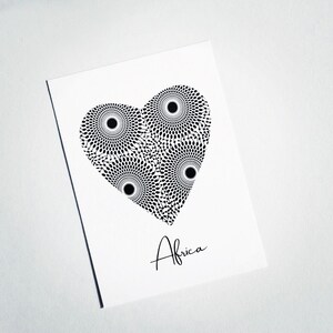 May include: A black and white heart-shaped design with a geometric pattern. The word "Africa" is written below the design.