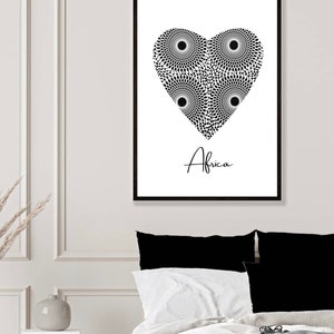 May include: Black and white print of a heart with a geometric pattern inside. The word "Africa" is written below the heart.