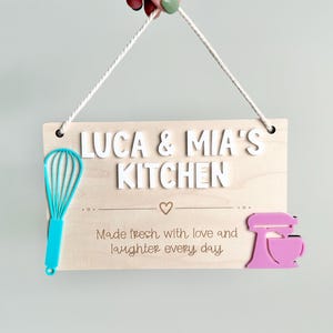 Wooden personalized play kitchen sign with whisk and mixer.
