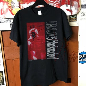 May include: Black t-shirt with a red image of a person and the text "DANZIG 5 Blackacidevil" printed on the front.
