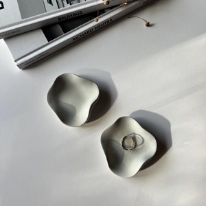 Minimalistic tray, with its organic shape, is a beautiful addition to any space. This mini ring dish is perfect for displaying jewelry and adding sophistication and elegance to any room.