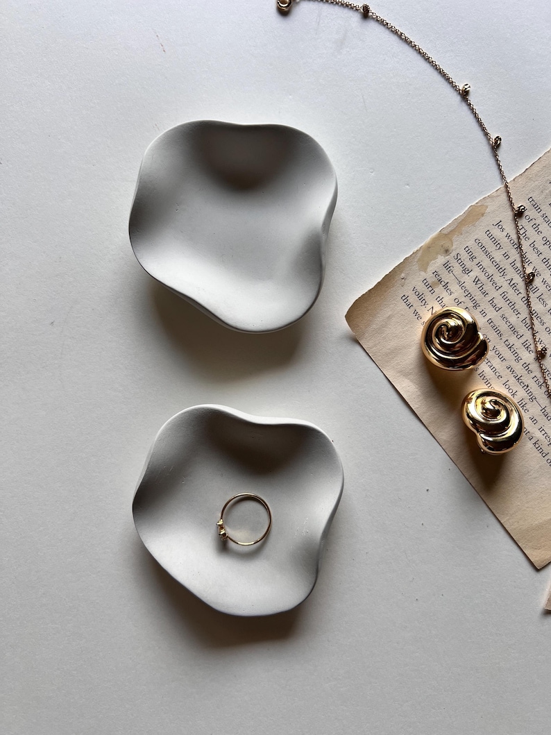 Mini minimalistic tray, with its organic shape, is a beautiful addition to any space. This mini ring dish is perfect for displaying jewelry and adding sophistication and elegance to any room.