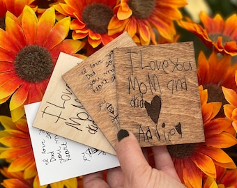 May include: Four wooden plaques with handwritten messages. The top plaque reads "I love you Mom and dad Addie". The other plaques have messages of love to Mom and Dad.