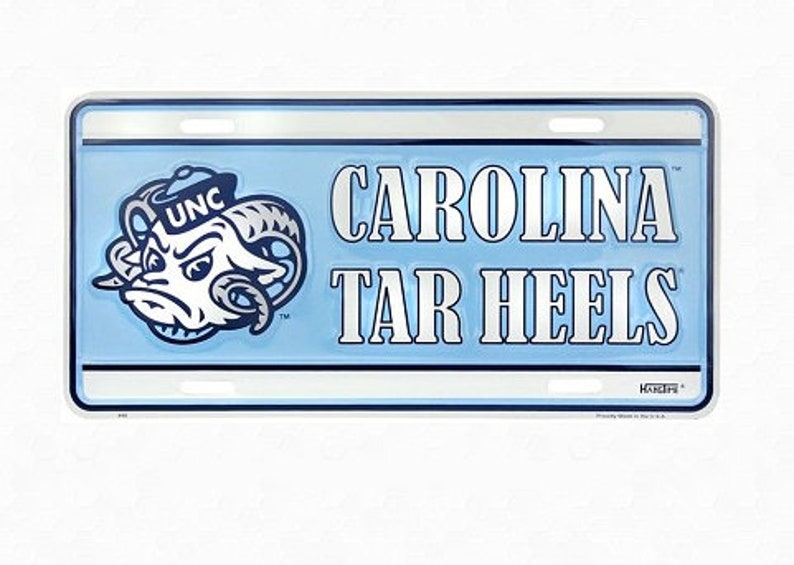 May include: A blue and white metal license plate with the words "CAROLINA TAR HEELS" and a cartoon ram mascot wearing a hat with the letters "UNC" on it.