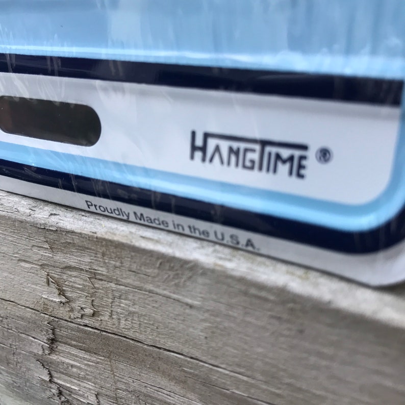 May include: Close-up of a blue and white sign with the text "Hangtime" and "Proudly Made in the U.S.A."