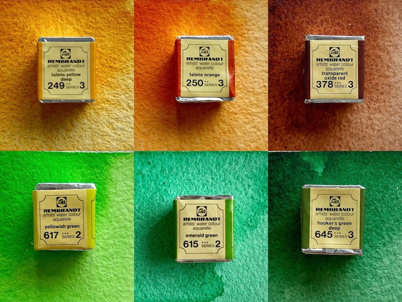 May include: Six watercolor paint tubes in a grid pattern. The tubes are labeled with the brand name "Rembrandt" and the color name. The colors are: Talens Yellow Deep, Talens Orange, Transparent Oxide Red, Yellowish Green, Emerald Green, and Hooker's Green Deep.