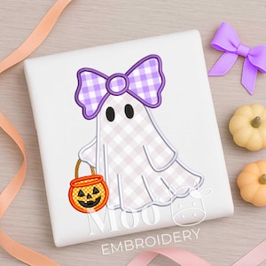 May include: A white square featuring a ghost design. The ghost has a purple and white checked bow, black eyes, and carries an orange jack-o'-lantern bucket. Two small pumpkins and a purple bow are also present.