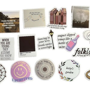 May include: A collection of stickers with various designs and text. The stickers feature images of a sweater, a ferris wheel, a bottle of wine, and text like "Folklore" and "Long Story Short". The color palette includes white, beige, and various shades of pink and purple.