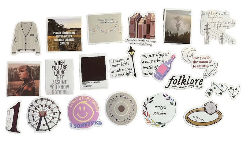 May include: A collection of stickers with various designs and text. The stickers feature images of a sweater, a ferris wheel, a bottle of wine, and text like "Folklore" and "Long Story Short". The color palette includes white, beige, and various shades of pink and purple.