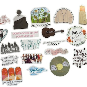 May include: A collection of various stickers with illustrations and text. Designs include a guitar, a greenhouse, a cardigan, floral arrangements, and phrases like "This is me Trying" and "Folklore". The stickers are in various colors, including beige, brown, and orange.