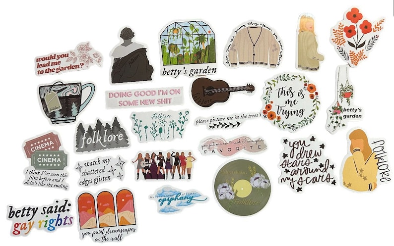 May include: A collection of various stickers with illustrations and text. Designs include a guitar, a greenhouse, a cardigan, floral arrangements, and phrases like "This is me Trying" and "Folklore". The stickers are in various colors, including beige, brown, and orange.