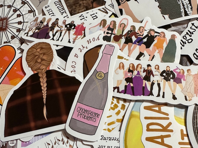 May include: A collection of stickers featuring illustrations of a singer and song lyrics. One sticker shows a champagne bottle with the text "Champagne Problems." Other stickers depict the singer in various outfits and poses. The stickers are in various colors.