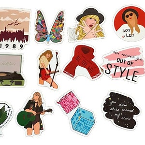 May include: A collection of colorful stickers featuring various illustrations and text. Designs include portraits, butterflies, a record player, the text "1989", and phrases like "Out of Style" and "Angels Roll the Dice".