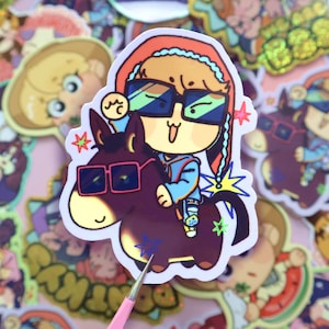 May include: A cartoon sticker of a person wearing a red and blue hat and sunglasses riding a brown donkey wearing sunglasses. The donkey has a star on its side and the person is holding a star in their hand.